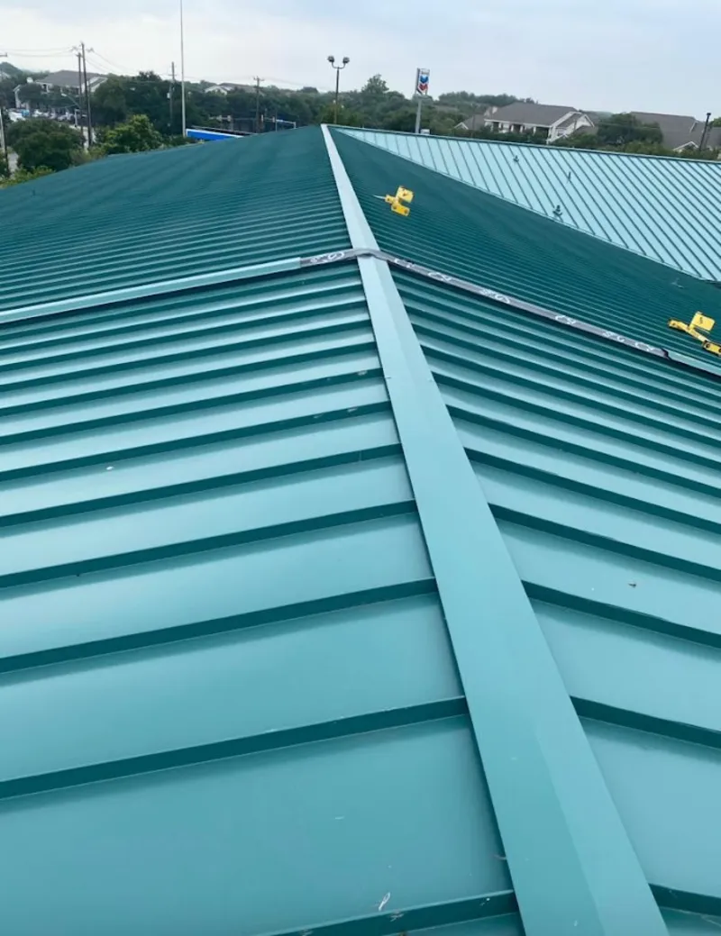 Green commercial metal roof ridge and valley for Metal Roof Repair in Richmond West