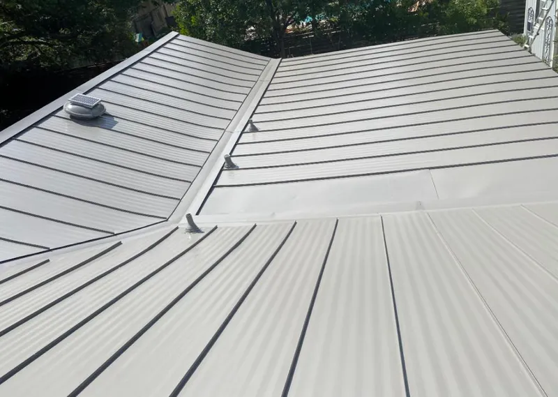 Solar attic fan installed on a metal roof for Roof Ventilation in Richmond West